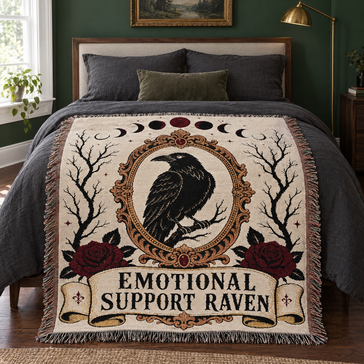 Emotional Support Raven woven blanket laid across the foot of a bed with charcoal linen in a forest green gothic bedroom