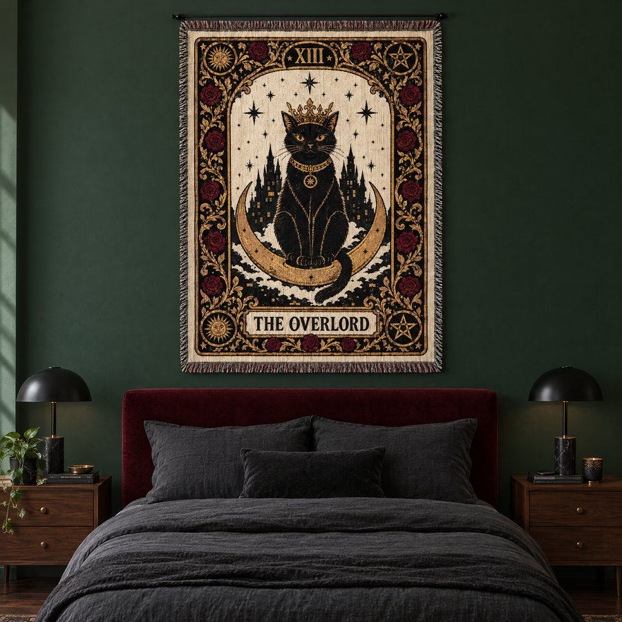 The Overlord black cat tarot woven tapestry hanging above a bed with an oxblood velvet headboard in a forest green bedroom