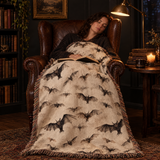 Bat woven blanket over a leather armchair while a woman dozes with a book in a dark reading room