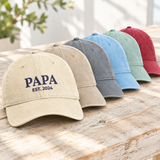 Stack of embroidered nickname dad hats in washed colours