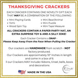 Information card listing what is inside each cracker, a novelty gift, a paper hat, a joke and a snap