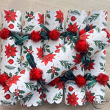 Red Christmas Flower crackers arranged on the diagonal showing the poinsettia print