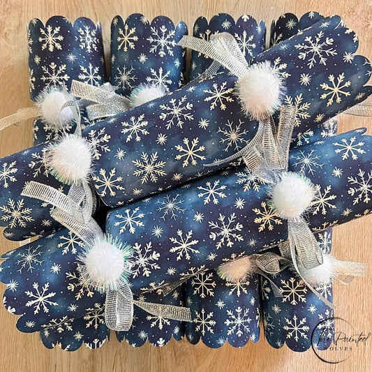 Navy blue snowflake Christmas crackers with silver ribbon and white pom poms