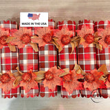 Set of six fall plaid crackers laid in a row for a Thanksgiving table