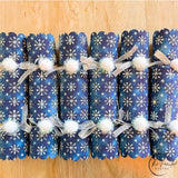 Set of six blue snowflake crackers lined up side by side
