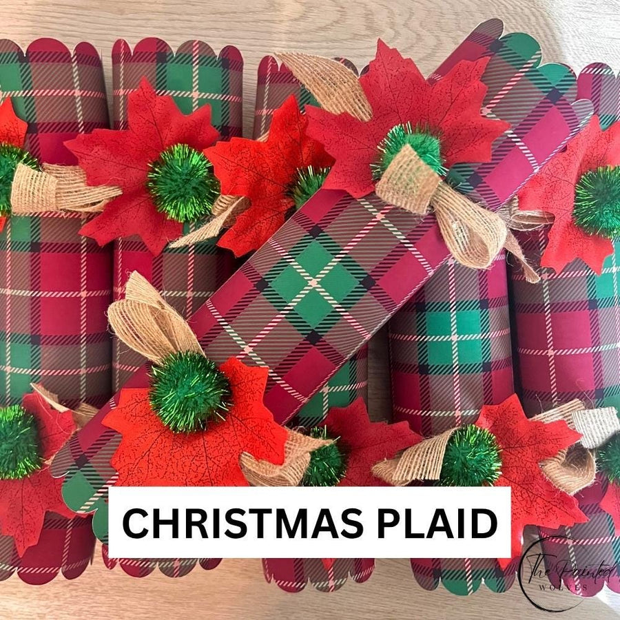 The Christmas Plaid design named on the photo, red and green tartan crackers with green pom poms