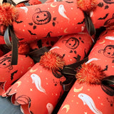 Close-up of Halloween crackers showing the hand-drawn jack-o'-lantern and ghost print