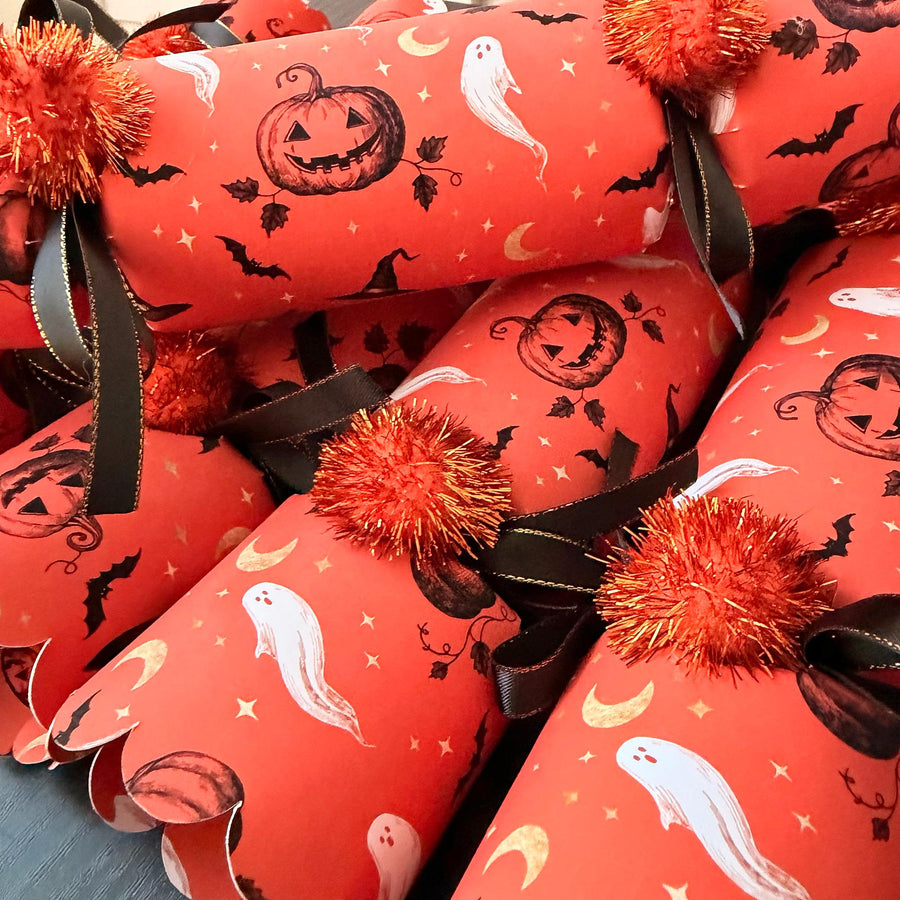Close-up of Halloween crackers showing the hand-drawn jack-o'-lantern and ghost print