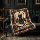 The Overlord black cat tarot woven blanket draped over a green velvet sofa in a gothic living room