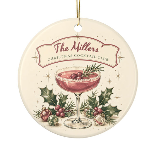 Round ceramic Christmas Cocktail Club ornament with a pink cocktail coupe, holly and baubles, example banner The Millers, gold string