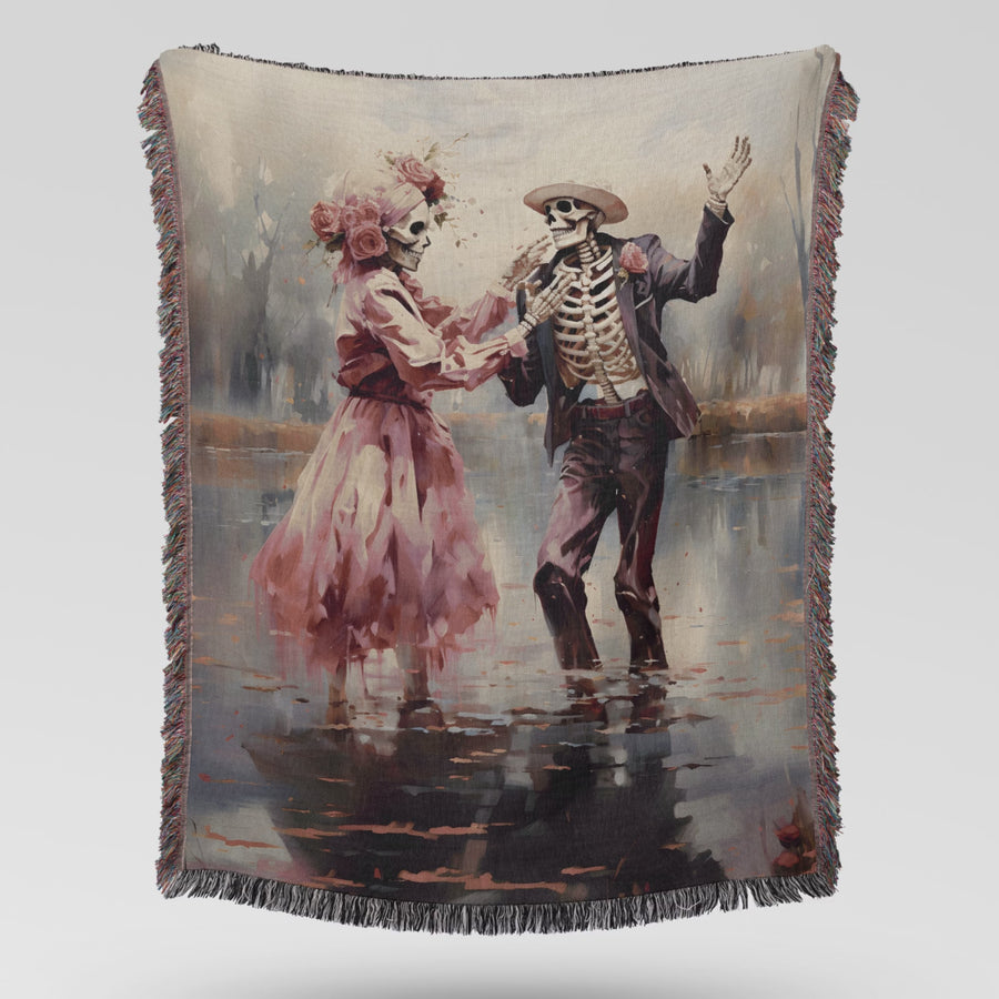 Video showing the pink skeleton couple woven blanket unfolding and draping