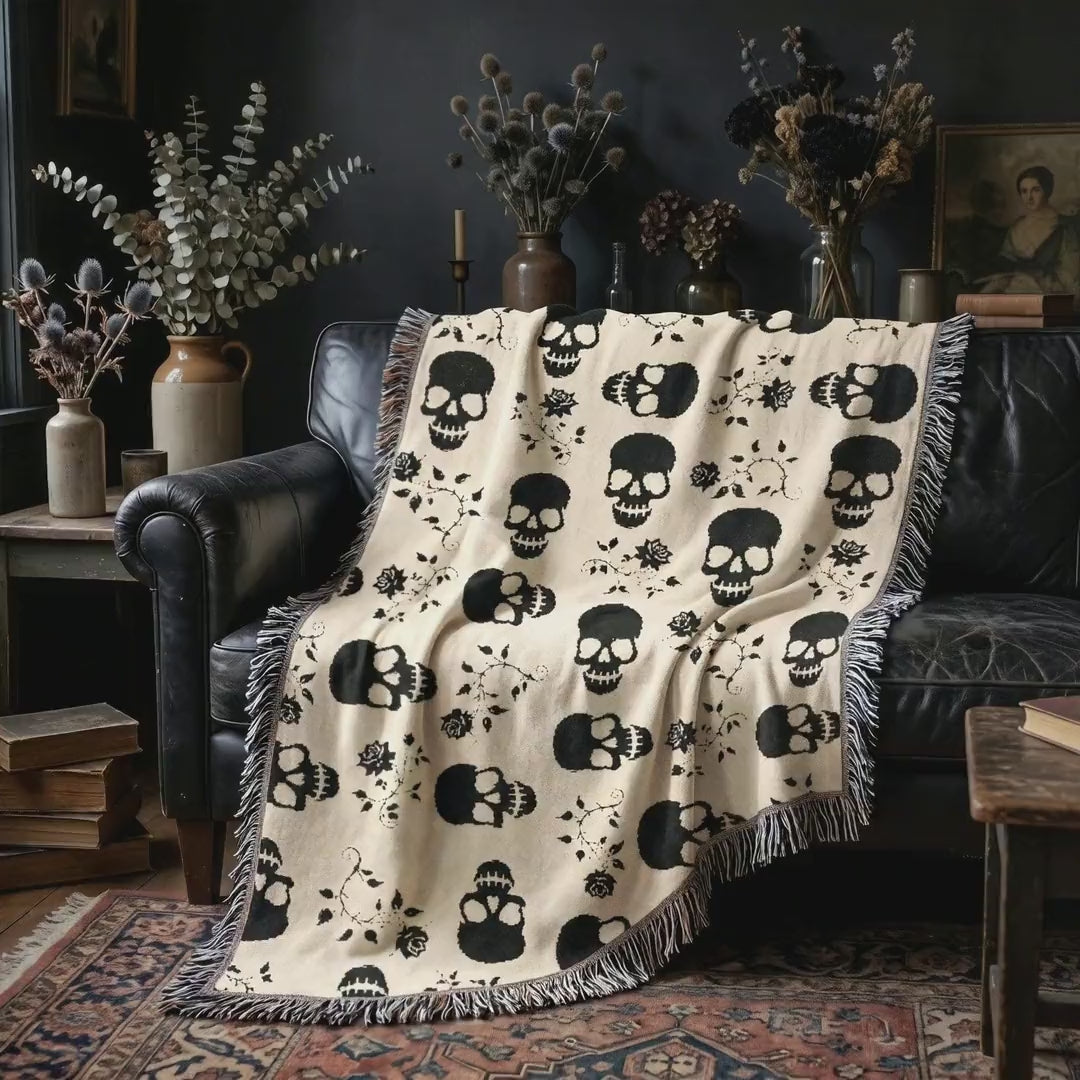 Short video of the black skull and roses woven blanket on a leather sofa