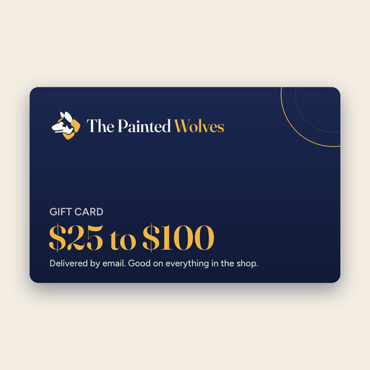 The Painted Wolves gift card, navy card with the wolf logo and $25 to $100 in gold